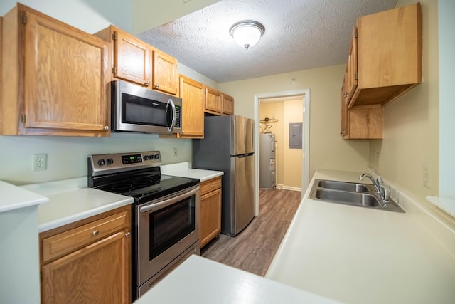 701 Napa Valley Ln Unit 9, Crestview Hills, KY 41017 - kitchen featuring stainless steel appliances, light wood-type flooring, electric panel, light countertops, and a textured ceiling