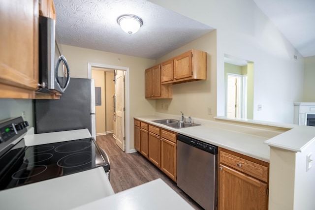 701 Napa Valley Ln Unit 9, Crestview Hills, KY 41017 - kitchen featuring appliances with stainless steel finishes, dark wood-type flooring, a peninsula, light countertops, and a textured ceiling