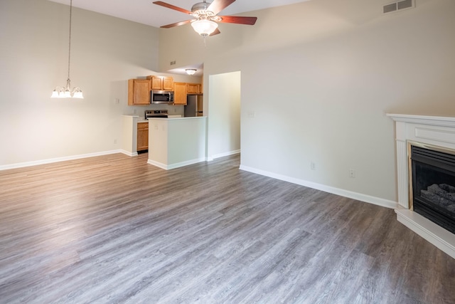701 Napa Valley Ln Unit 9, Crestview Hills, KY 41017 - unfurnished living room with high vaulted ceiling, ceiling fan, a fireplace, wood finished floors, and a chandelier
