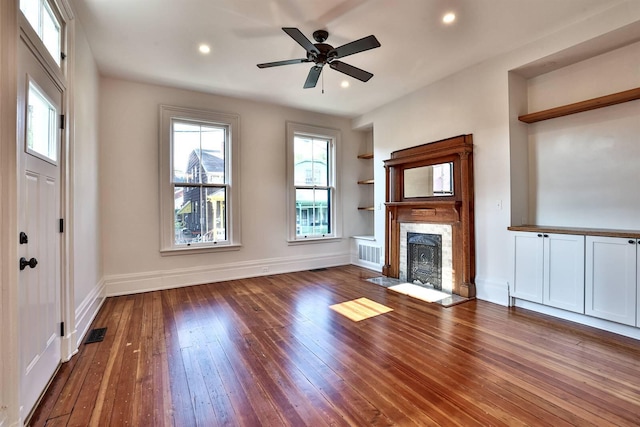 410 Emma St, Covington, KY 41011 - unfurnished living room featuring built in features, hardwood / wood-style flooring, a fireplace with flush hearth, recessed lighting, and a ceiling fan