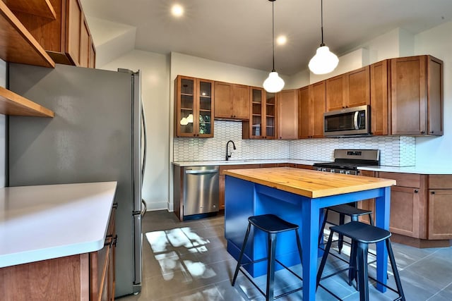 410 Emma St, Covington, KY 41011 - kitchen with appliances with stainless steel finishes, wooden counters, open shelves, tasteful backsplash, and dark tile patterned flooring