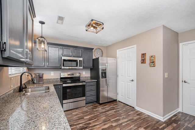2139 Algiers St, Union, KY 41091 - kitchen with stainless steel appliances, a sink, dark wood-style flooring, baseboards, and light stone countertops