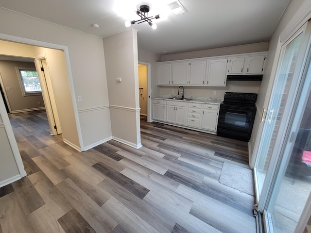 6859 Curtis Way, Florence, KY 41042 - kitchen featuring black range with electric cooktop, ventilation hood, white cabinetry, light wood-style floors, and light countertops