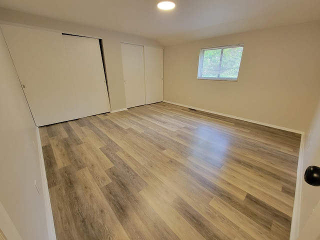 6859 Curtis Way, Florence, KY 41042 - unfurnished bedroom with light wood-style flooring and multiple closets