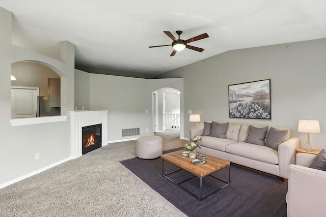 2225 Rolling Hills Dr, Covington, KY 41017 - carpeted living room featuring arched walkways, lofted ceiling, a ceiling fan, and a glass covered fireplace