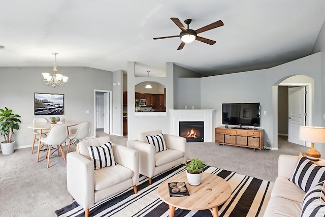 2225 Rolling Hills Dr, Covington, KY 41017 - carpeted living room with vaulted ceiling, a ceiling fan, a warm lit fireplace, a chandelier, and arched walkways
