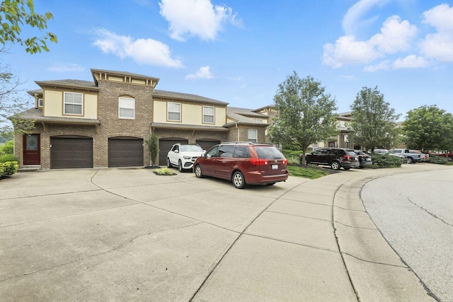 2225 Rolling Hills Dr, Covington, KY 41017 - view of front of home with driveway, an attached garage, and brick siding