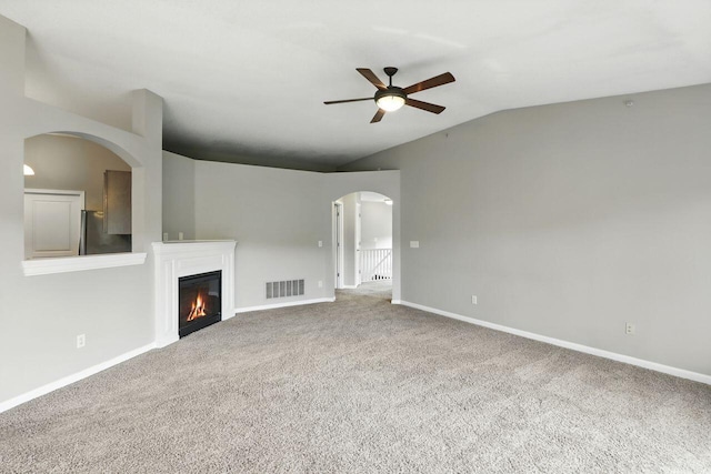 2225 Rolling Hills Dr, Covington, KY 41017 - unfurnished living room featuring ceiling fan, lofted ceiling, carpet floors, a glass covered fireplace, and arched walkways