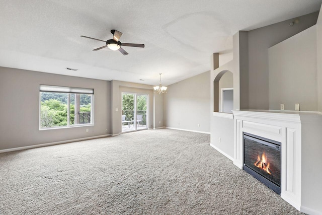 2225 Rolling Hills Dr, Covington, KY 41017 - unfurnished living room with carpet, a glass covered fireplace, a chandelier, ceiling fan, and vaulted ceiling
