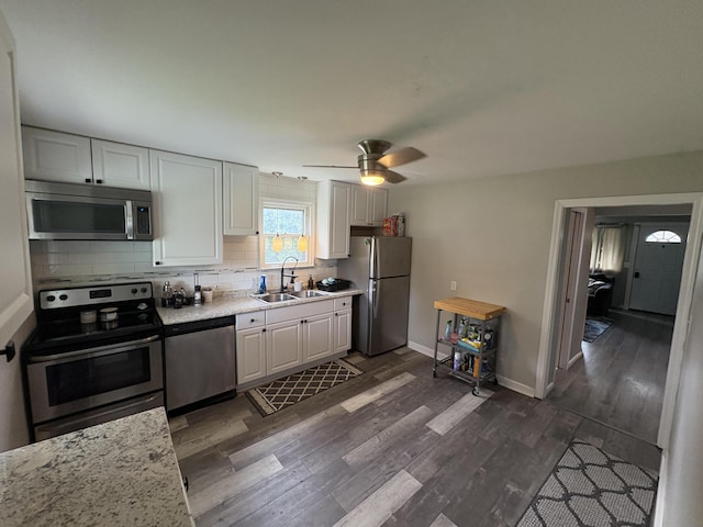 107 W 1st St, Silver Grove, KY 41085 - kitchen featuring appliances with stainless steel finishes, dark wood-type flooring, tasteful backsplash, white cabinetry, and ceiling fan