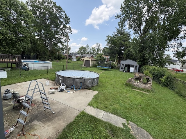 107 W 1st St, Silver Grove, KY 41085 - view of yard with a storage shed, a trampoline, and an outdoor pool