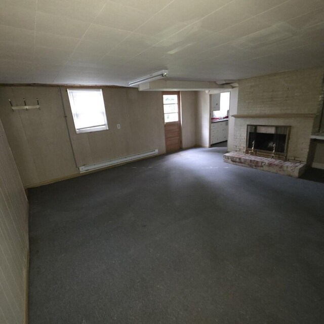 106 Roland Ave, Owenton, KY 40359 - unfurnished living room with a baseboard radiator, a fireplace, and dark carpet