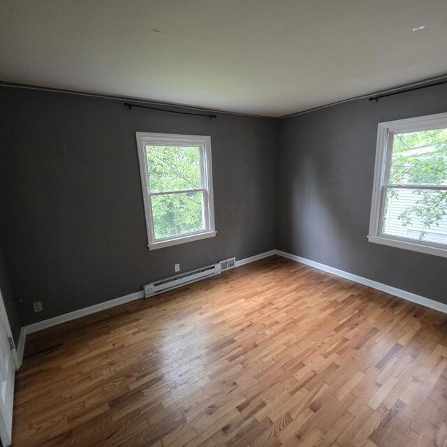 106 Roland Ave, Owenton, KY 40359 - spare room with a baseboard radiator, wood finished floors, and baseboards