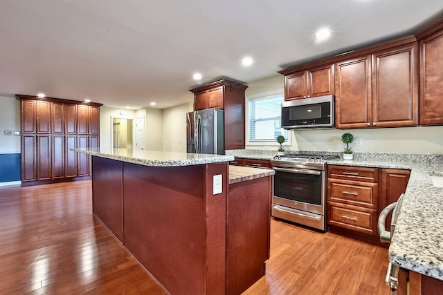 724 Dudley Rd, Edgewood, KY 41017 - kitchen featuring stainless steel appliances, a center island, light wood-style floors, recessed lighting, and light stone counters