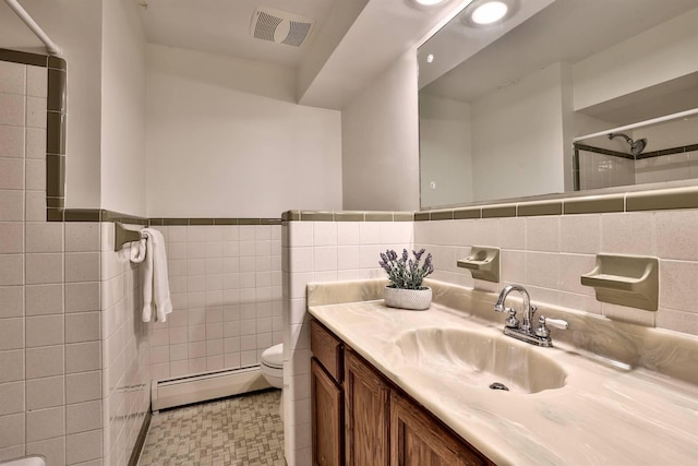 724 Dudley Rd, Edgewood, KY 41017 - bathroom featuring baseboard heating, tile walls, vanity, tiled shower, and wainscoting