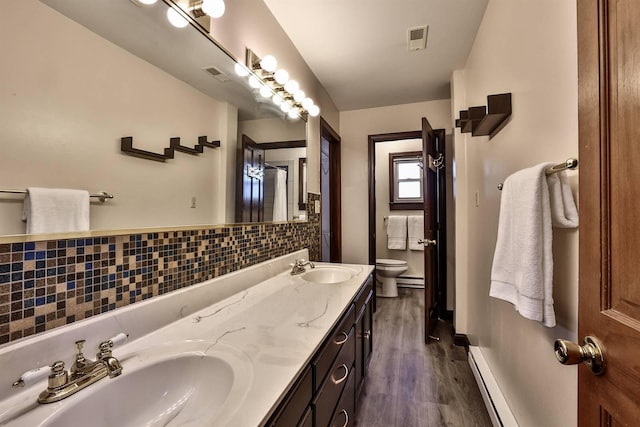 724 Dudley Rd, Edgewood, KY 41017 - full bathroom featuring double vanity, wood finished floors, a baseboard heating unit, and a baseboard radiator