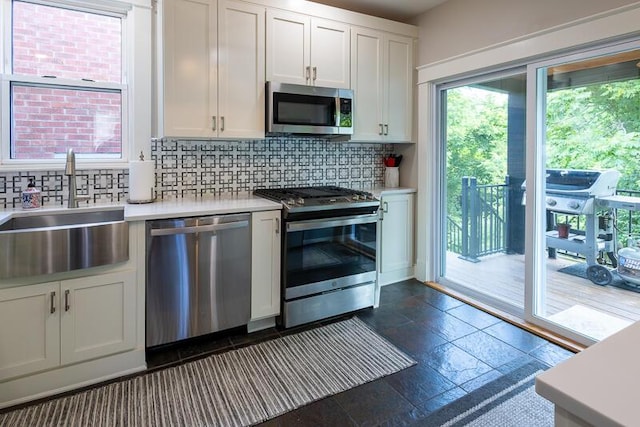 386 Linden Ave, Southgate, KY 41071 - kitchen with appliances with stainless steel finishes, light countertops, backsplash, and stone tile floors