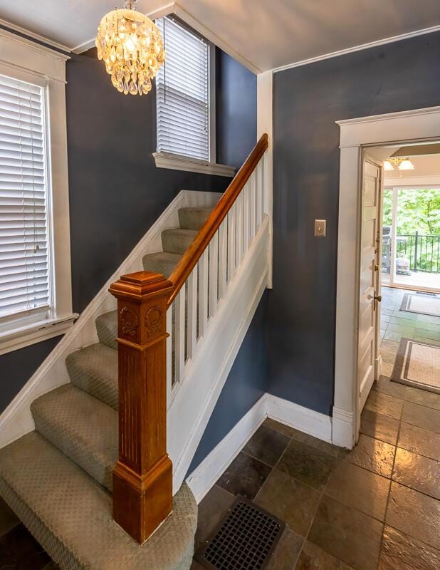 386 Linden Ave, Southgate, KY 41071 - staircase with a chandelier, stone tile flooring, and ornamental molding