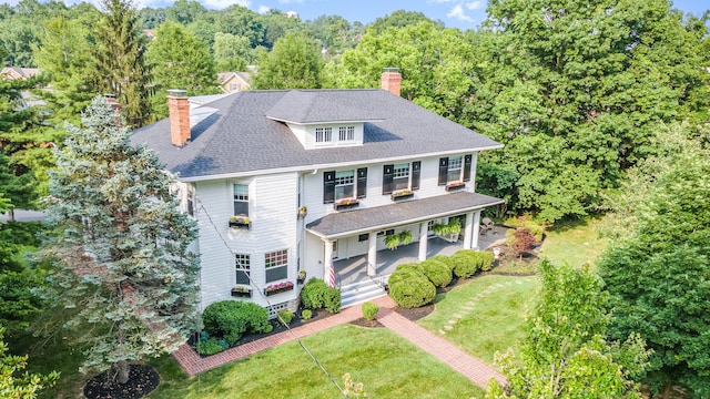 34 Ridge Rd, Fort Mitchell, KY 41011 - traditional style home featuring a chimney, covered porch, a front lawn, roof with shingles, and a forest view