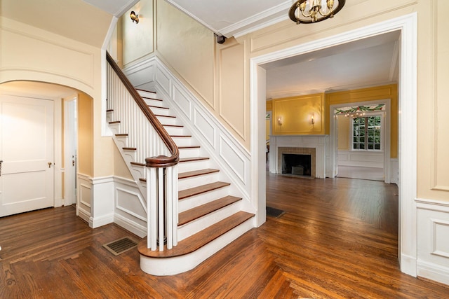 34 Ridge Rd, Fort Mitchell, KY 41011 - stairway with a decorative wall, a fireplace, crown molding, and arched walkways