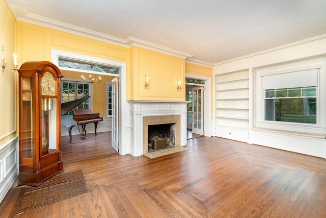 34 Ridge Rd, Fort Mitchell, KY 41011 - living room with crown molding, a chandelier, built in shelves, a tile fireplace, and a decorative wall