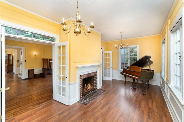 34 Ridge Rd, Fort Mitchell, KY 41011 - living room featuring a chandelier, a decorative wall, french doors, wood finished floors, and ornamental molding