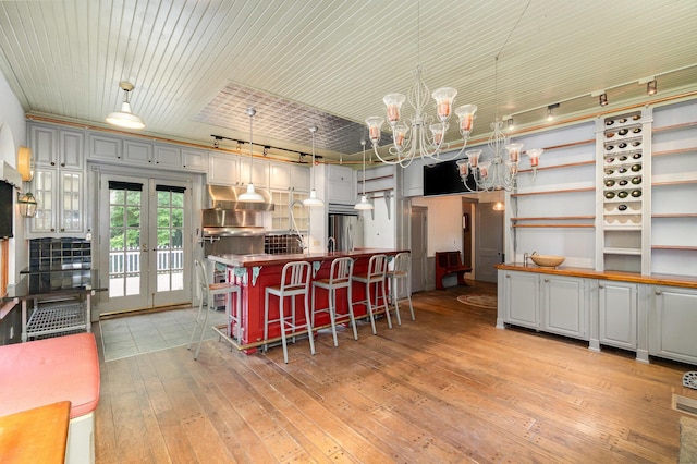 34 Ridge Rd, Fort Mitchell, KY 41011 - kitchen featuring a chandelier, freestanding refrigerator, light wood finished floors, decorative light fixtures, and open shelves