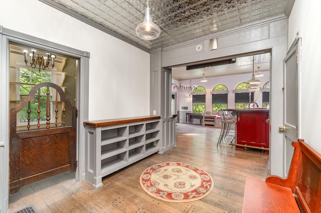34 Ridge Rd, Fort Mitchell, KY 41011 - entryway featuring a chandelier, crown molding, an ornate ceiling, hardwood / wood-style flooring, and healthy amount of natural light