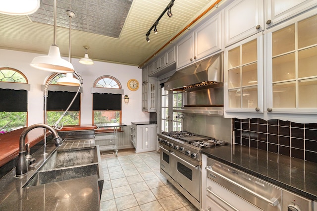 34 Ridge Rd, Fort Mitchell, KY 41011 - kitchen with range with two ovens, under cabinet range hood, a warming drawer, light tile patterned floors, and hanging light fixtures