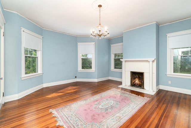 34 Ridge Rd, Fort Mitchell, KY 41011 - unfurnished living room featuring healthy amount of natural light, a chandelier, hardwood / wood-style floors, a fireplace, and crown molding