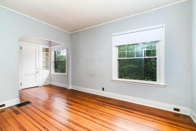 34 Ridge Rd, Fort Mitchell, KY 41011 - empty room with crown molding, wood finished floors, arched walkways, and plenty of natural light