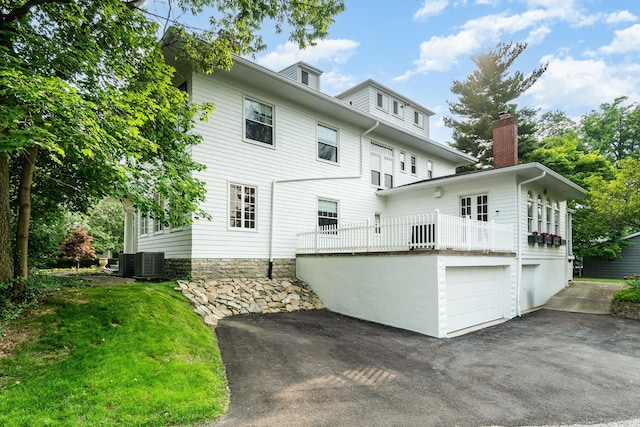 34 Ridge Rd, Fort Mitchell, KY 41011 - rear view of house featuring asphalt driveway, a chimney, a balcony, and a garage