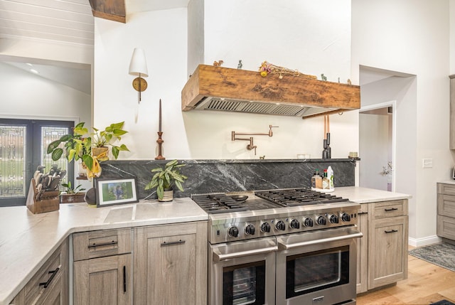 2003 Pieck Dr, Fort Wright, KY 41011 - kitchen with double oven range, premium range hood, lofted ceiling, light wood-style floors, and backsplash