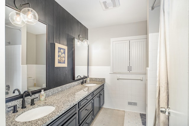 2003 Pieck Dr, Fort Wright, KY 41011 - bathroom with tile walls, double vanity, wainscoting, and tile patterned floors