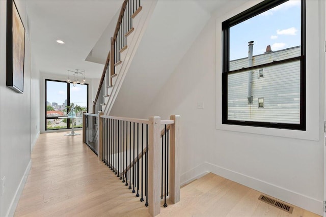 76 W 13th St Unit 34, Newport, KY 41071 - corridor featuring light wood-type flooring and a chandelier