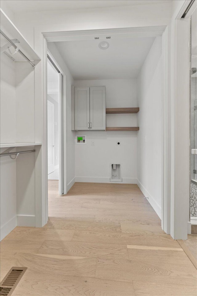 76 W 13th St Unit 34, Newport, KY 41071 - laundry area featuring washer hookup, light wood finished floors, hookup for an electric dryer, and cabinet space