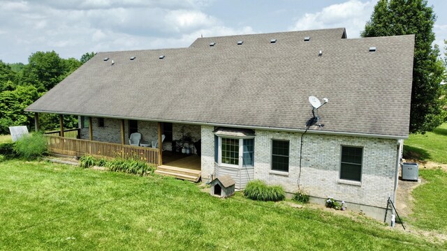 3745 Sweet Owen Rd, Owenton, KY 40359 - rear view of house with brick siding, a lawn, central air condition unit, a wooden deck, and a shingled roof