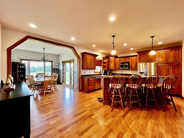 3745 Sweet Owen Rd, Owenton, KY 40359 - kitchen featuring appliances with stainless steel finishes, light wood-type flooring, recessed lighting, a kitchen island, and decorative light fixtures