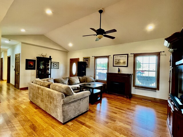 3745 Sweet Owen Rd, Owenton, KY 40359 - living area featuring vaulted ceiling, a fireplace, light wood finished floors, a ceiling fan, and baseboards
