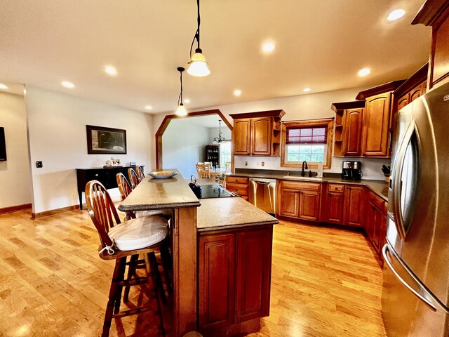 3745 Sweet Owen Rd, Owenton, KY 40359 - kitchen featuring appliances with stainless steel finishes, a sink, a center island, light wood finished floors, and a kitchen bar