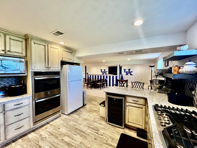 3745 Sweet Owen Rd, Owenton, KY 40359 - kitchen with beverage cooler, appliances with stainless steel finishes, light wood-style flooring, a peninsula, and recessed lighting
