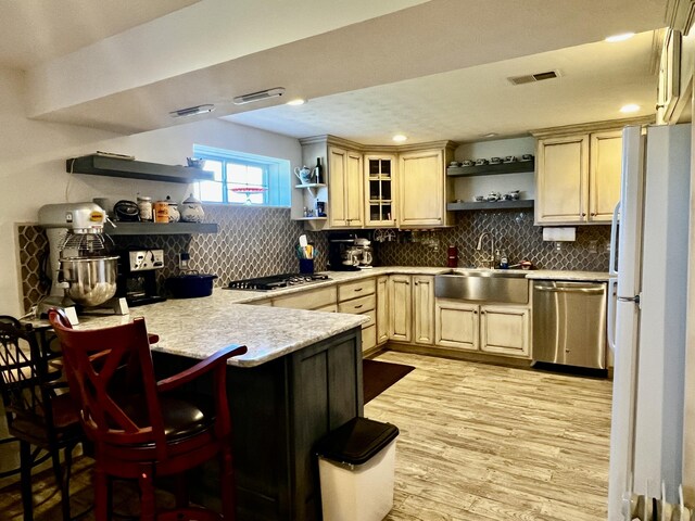 3745 Sweet Owen Rd, Owenton, KY 40359 - kitchen with open shelves, appliances with stainless steel finishes, a sink, a peninsula, and tasteful backsplash