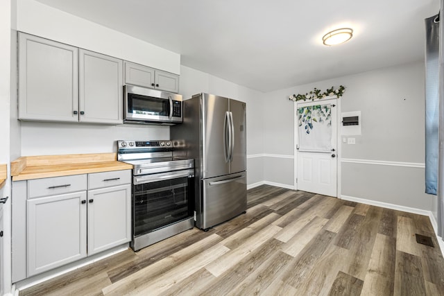 3771 Feather Ln, Elsmere, KY 41018 - kitchen featuring stainless steel appliances, light wood-type flooring, and butcher block counters