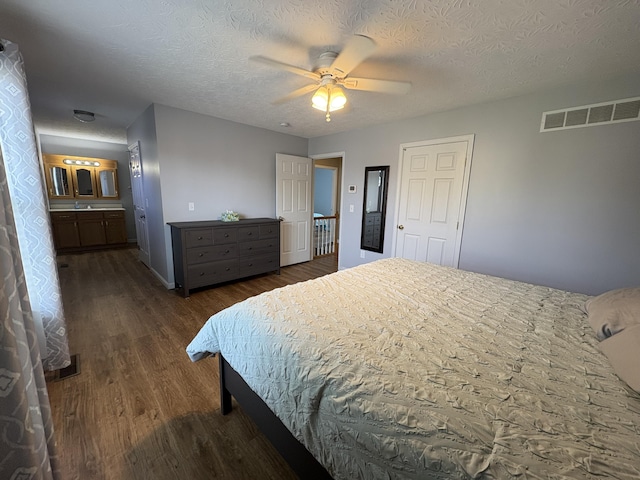 301 Fairway Dr, Dry Ridge, KY 41035 - bedroom featuring dark wood-type flooring, ensuite bathroom, a ceiling fan, and a textured ceiling