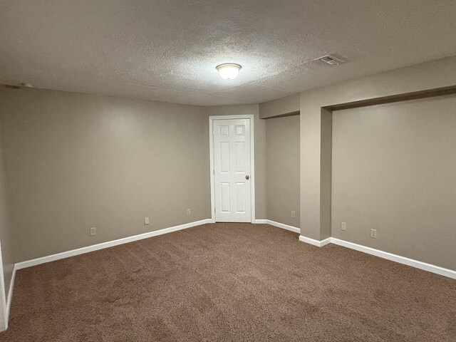 301 Fairway Dr, Dry Ridge, KY 41035 - unfurnished bedroom with a textured ceiling, dark carpet, and multiple closets