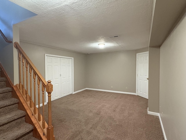 301 Fairway Dr, Dry Ridge, KY 41035 - basement featuring a textured ceiling, dark colored carpet, and stairs