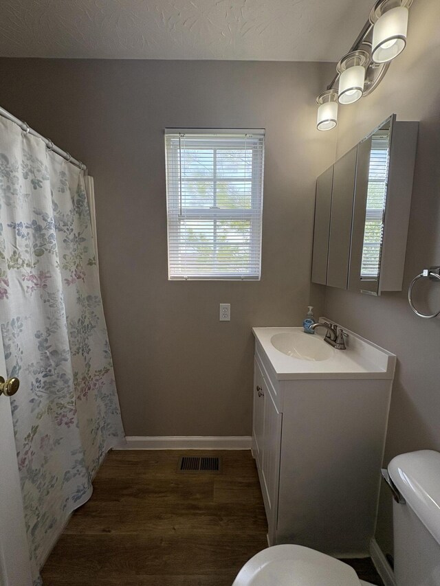 301 Fairway Dr, Dry Ridge, KY 41035 - full bath with wood finished floors, vanity, and a shower with shower curtain