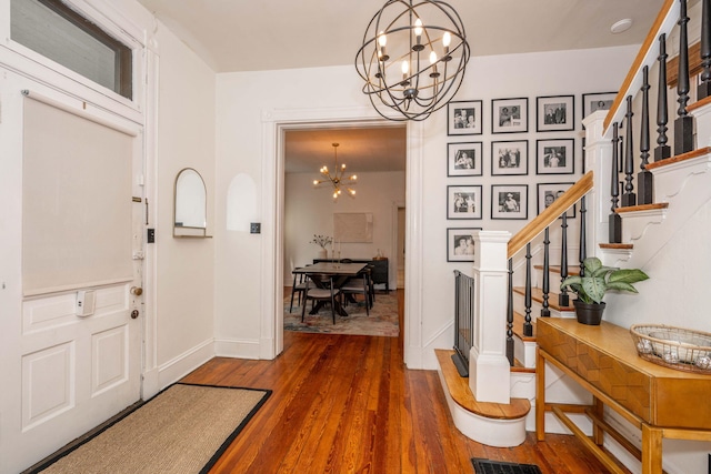 1915 Scott St, Covington, KY 41014 - foyer featuring a chandelier, stairs, and wood-type flooring