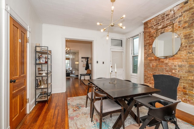 1915 Scott St, Covington, KY 41014 - dining space with hardwood / wood-style flooring, ornamental molding, a chandelier, and brick wall