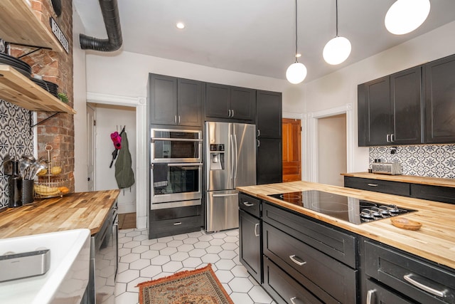 1915 Scott St, Covington, KY 41014 - kitchen featuring wood counters, appliances with stainless steel finishes, tasteful backsplash, and hanging light fixtures